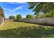 A well-manicured backyard featuring green grass and a wooden fence at 11554 Blackmoor Dr, Orlando, FL 32837