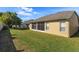 Exterior view of the backyard, the screened in lanai and windows at 11554 Blackmoor Dr, Orlando, FL 32837