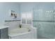 Modern bathroom featuring a soaking tub and a glass-enclosed shower at 11554 Blackmoor Dr, Orlando, FL 32837