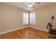 This bedroom features hardwood floors, a ceiling fan and large windows with plantation shutters at 11554 Blackmoor Dr, Orlando, FL 32837