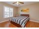 Bedroom with wood floors, ceiling fan, plantation shutters and wall art at 11554 Blackmoor Dr, Orlando, FL 32837