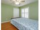 Bedroom with wood floors, ceiling fan, plantation shutters and closet at 11554 Blackmoor Dr, Orlando, FL 32837