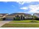 Charming single-story home with manicured lawn, arched entryway, and a two-car garage at 11554 Blackmoor Dr, Orlando, FL 32837