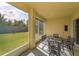 Screened lanai with tile floors and metal table and chairs overlooking backyard at 11554 Blackmoor Dr, Orlando, FL 32837