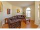 Cozy living room with hardwood floors, comfortable seating, and natural light streaming through the window at 11554 Blackmoor Dr, Orlando, FL 32837