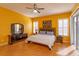 Comfortable bedroom with hardwood floors, a ceiling fan and large windows at 11554 Blackmoor Dr, Orlando, FL 32837