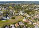 An aerial view of a well maintained neighborhood with mature trees and landscaping at 1243 Osprey Way, Apopka, FL 32712