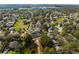 An aerial view of a well maintained neighborhood with mature trees and landscaping at 1243 Osprey Way, Apopka, FL 32712