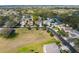 An aerial view of a well maintained neighborhood with mature trees and landscaping at 1243 Osprey Way, Apopka, FL 32712