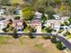 An aerial view of a well maintained neighborhood with mature trees and landscaping at 1243 Osprey Way, Apopka, FL 32712