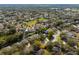 An aerial view of a well maintained neighborhood with mature trees and landscaping at 1243 Osprey Way, Apopka, FL 32712