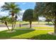 Beautiful front yard with a lush green lawn and mature trees and bushes at 1243 Osprey Way, Apopka, FL 32712