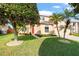 Charming two-story home with a manicured front yard and a bright red front door at 1243 Osprey Way, Apopka, FL 32712