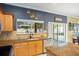 Well-lit kitchen with a view of the lanai, stainless steel appliances, and granite countertops at 1243 Osprey Way, Apopka, FL 32712