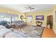 Cozy living room with a ceiling fan, window blinds, and neutral-toned furniture at 1243 Osprey Way, Apopka, FL 32712