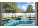 Sparkling blue pool surrounded by a screened-in enclosure, providing a serene and private outdoor experience at 1243 Osprey Way, Apopka, FL 32712