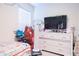 Relaxing bedroom featuring a dresser, TV and decorative lighting at 1260 Berry Ln, Davenport, FL 33837