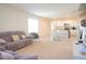 Spacious living room view showcases the kitchen, a comfortable sofa, and an open-concept design for modern living at 1260 Berry Ln, Davenport, FL 33837