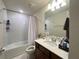 Clean bathroom with a shower-tub combo and a spacious vanity with great lighting at 14388 Orchild Island Dr, Orlando, FL 32827