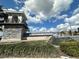 Striking entrance to Isles of Lake Nona with stone tower, cascading fountain, and lush landscaping at 14388 Orchild Island Dr, Orlando, FL 32827