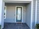 The front door of the house with a black and white rug in front of it at 14388 Orchild Island Dr, Orlando, FL 32827