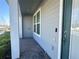 The walkway to the front door with grey siding and white columns at 14388 Orchild Island Dr, Orlando, FL 32827