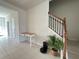 Hallway with tile floors leading to the stairs with small desk at 14388 Orchild Island Dr, Orlando, FL 32827