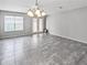 Bright dining area featuring tile flooring, a modern chandelier and access to the outdoor patio at 15574 Murcott Blossom Blvd, Winter Garden, FL 34787