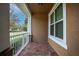 Welcoming front porch features brick flooring, white railings, and a cozy spot to enjoy the neighborhood views at 15574 Murcott Blossom Blvd, Winter Garden, FL 34787