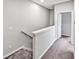 Upstairs hallway with carpet, leading to bedrooms, bathroom and other living spaces at 15574 Murcott Blossom Blvd, Winter Garden, FL 34787