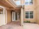 A lovely back patio featuring brick pavers and double doors that lead inside the home at 15574 Murcott Blossom Blvd, Winter Garden, FL 34787