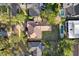 Aerial view showcasing the home's tile roof, expansive backyard, and proximity to nearby pools at 1690 Oneco Ave, Winter Park, FL 32789