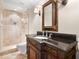 Bathroom showcases a glass walk-in shower, granite countertops, antique wood vanity, and tile floors at 1690 Oneco Ave, Winter Park, FL 32789