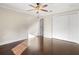 Spacious bedroom featuring hardwood floors, a ceiling fan, and a large closet for ample storage at 1690 Oneco Ave, Winter Park, FL 32789