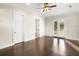 Bedroom features hardwood flooring, neutral paint, a ceiling fan, and access to the ensuite at 1690 Oneco Ave, Winter Park, FL 32789