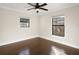 Bright bedroom with hardwood floors, ceiling fan, and plenty of natural light from two windows at 1690 Oneco Ave, Winter Park, FL 32789