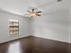 Neutral bedroom with hardwood floors, ceiling fan, and natural light from a window at 1690 Oneco Ave, Winter Park, FL 32789