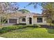 Charming single-story home with a well-maintained lawn, stucco facade, and a beautiful terracotta tile roof at 1690 Oneco Ave, Winter Park, FL 32789