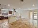 Open kitchen features travertine flooring, a white island, and stainless vent hood at 1690 Oneco Ave, Winter Park, FL 32789
