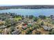 Aerial view of a home near a large lake, surrounded by mature trees and residential properties at 17445 Hillside Dr, Montverde, FL 34756