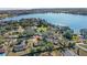 Aerial view of a home with mature trees near the water and a lush green yard at 17445 Hillside Dr, Montverde, FL 34756