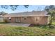 View of the backyard featuring a patio, green grass and the back of the home at 17445 Hillside Dr, Montverde, FL 34756