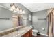 Bathroom with granite countertops, shower, and tiled walls in neutral tones at 17445 Hillside Dr, Montverde, FL 34756