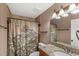 Bathroom featuring a shower with themed curtain, granite vanity, and bronze fixtures at 17445 Hillside Dr, Montverde, FL 34756