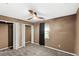 This bedroom features neutral walls, carpet floors, a fan, and a small window at 17445 Hillside Dr, Montverde, FL 34756