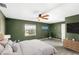 Green main bedroom with large ceiling fan, window, and an entertainment center on the wall at 17445 Hillside Dr, Montverde, FL 34756