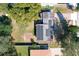 Aerial view of the house with a flat roof featuring solar panels and a spacious backyard at 1816 Jasper Drive, Orlando, FL 32807