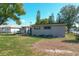 View of the backyard with a storage shed, trampoline, and plenty of green space at 1816 Jasper Drive, Orlando, FL 32807