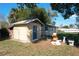 Backyard shed with a door and a window, complemented by green grass and a clear sky at 1816 Jasper Drive, Orlando, FL 32807