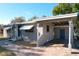 Side exterior view of a charming home featuring a covered carport and brick walkway at 1816 Jasper Drive, Orlando, FL 32807